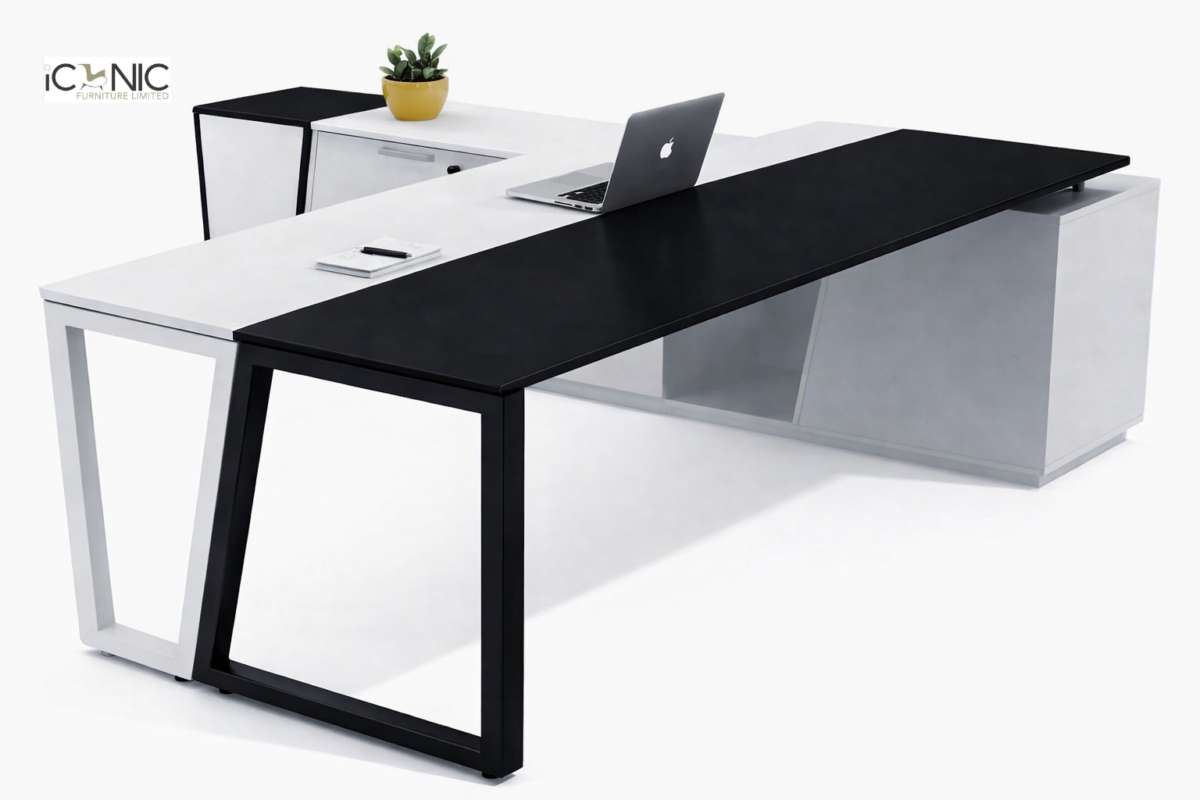 Modern L-shaped executive director table with walnut wood finish, integrated side storage cabinet, and matte black work surface by Iconic Furniture.
