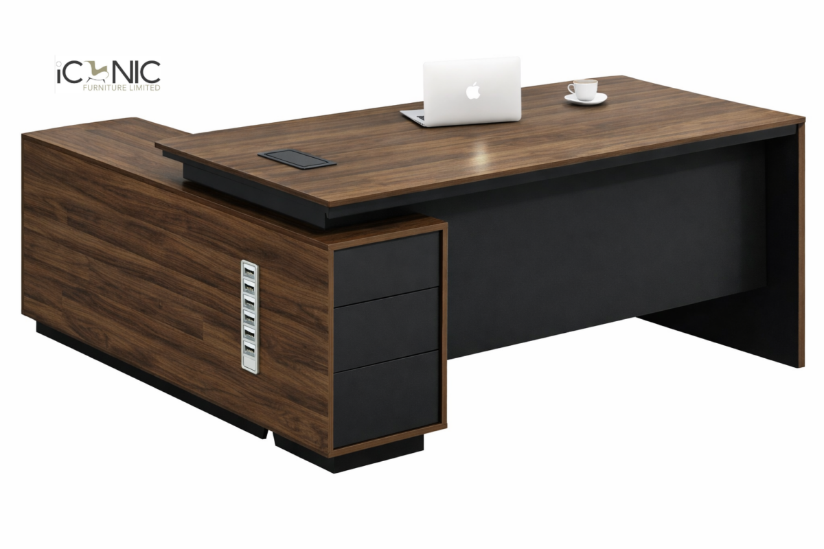 Top view of L-shaped director table with walnut wood finish, black writing pad, and side storage return cabinet.