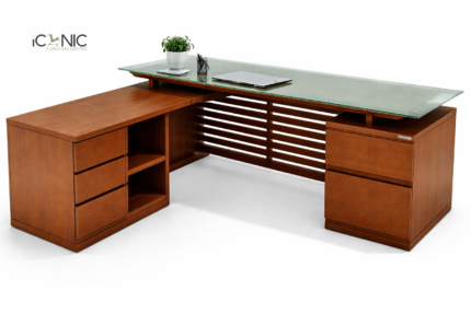 Premium L-shaped executive director table in walnut finish with integrated side storage and a black leatherette work surface.