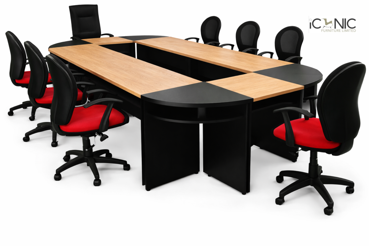 Large U-shaped wooden and black modular conference table with red and black mesh chairs by Iconic Furniture Limited.
